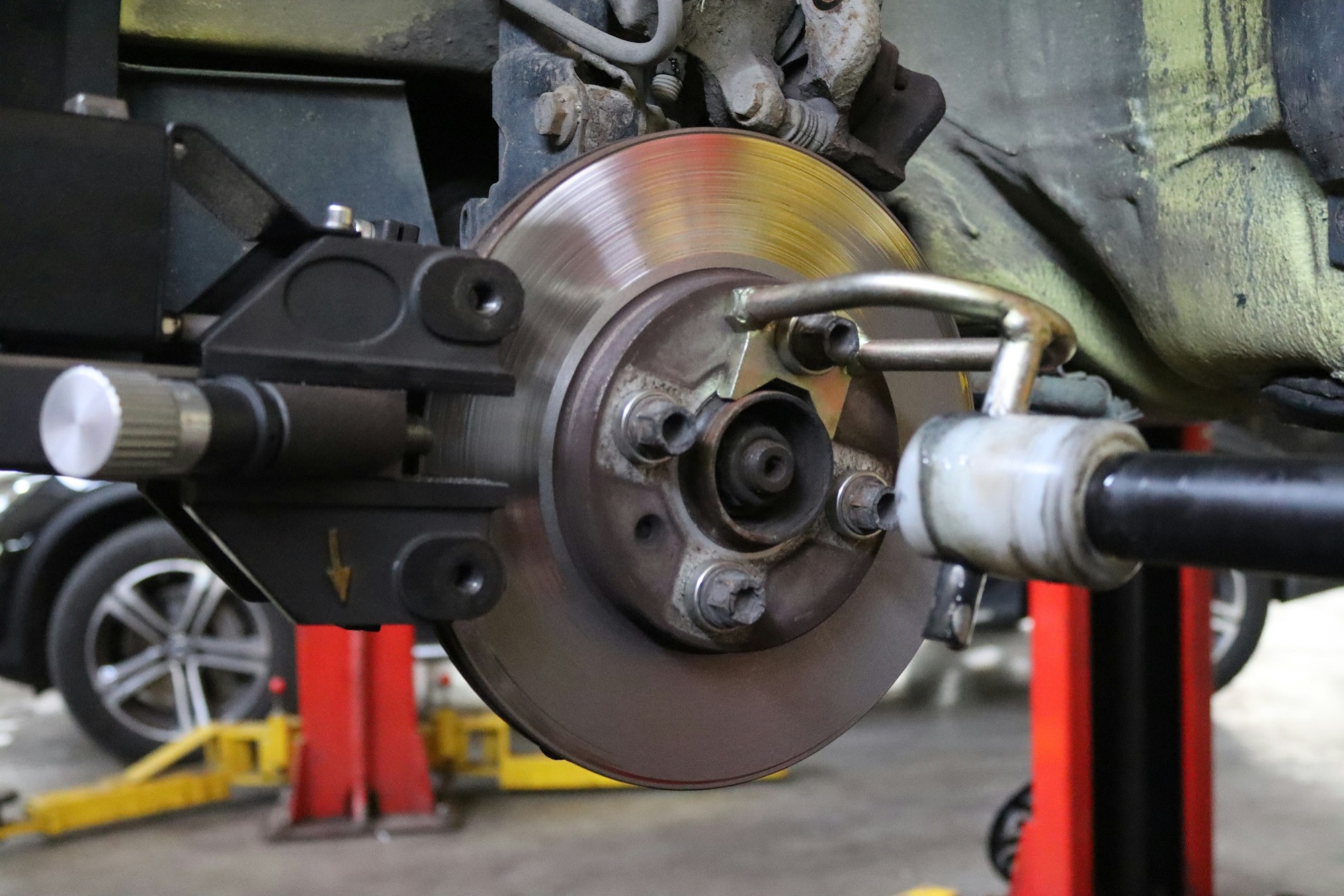 A brake rotor being resurfaced on the car with an on-car brake lathe
