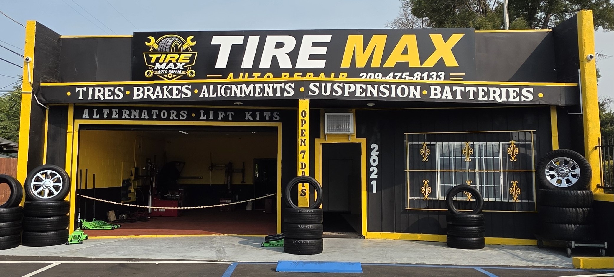 The Tire Max Auto Repair shop on E Harding Way in Stockton, with its open service bay and tires stacked out front